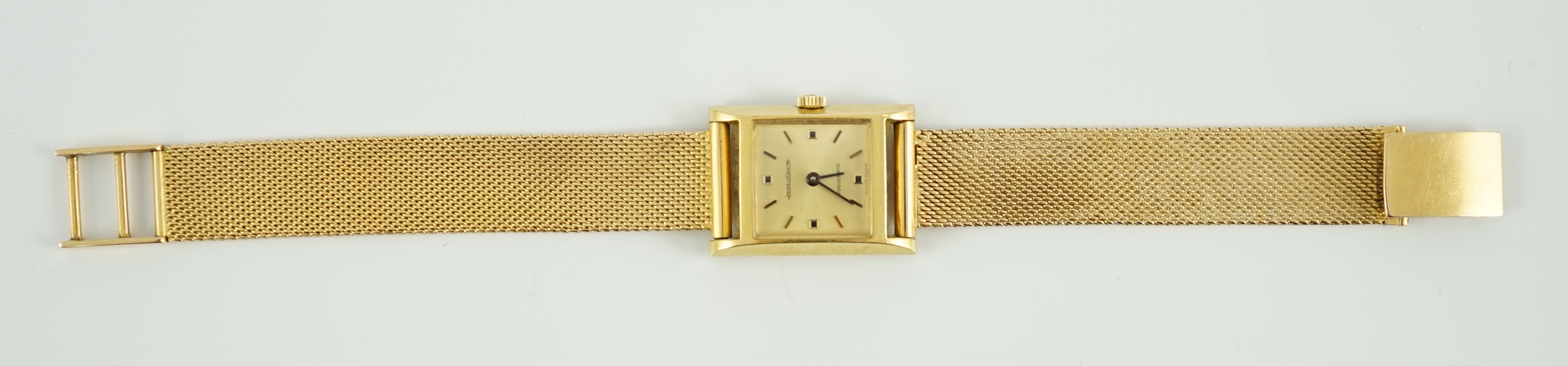 A lady's 18ct gold Jaeger LeCoultre Voguematic automatic rectangular wrist watch, on an associated Middle Eastern gold mesh link bracelet